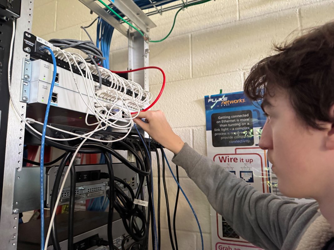 Student working on a live network rack